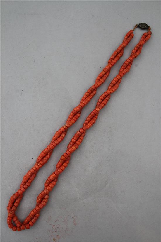 A Chinese double strand coral bead necklace, 24in.